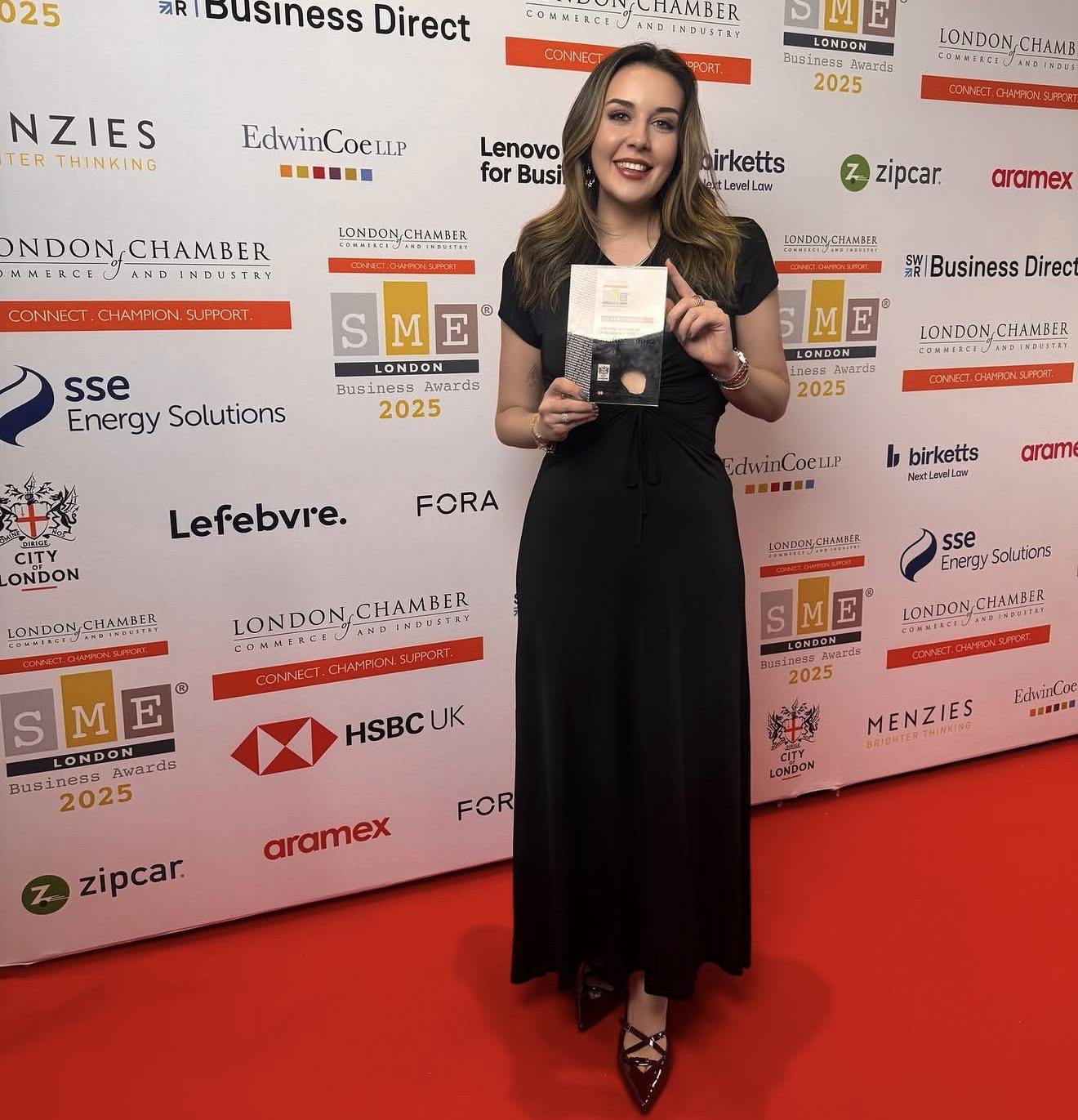 Alinda Kring holding her Young Business Person of the Year award on the red carpet at the SME London Business Awards 2025