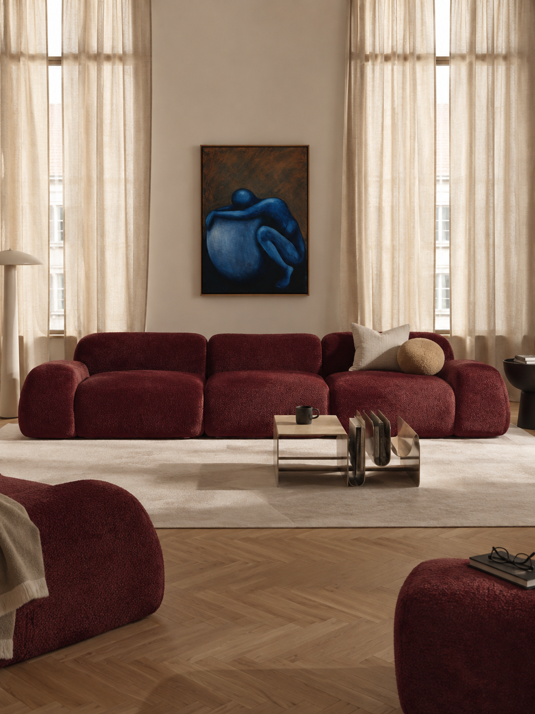 Illustrative living room with a blue figurative painting above a burgundy sofa (representative image, not the actual project)